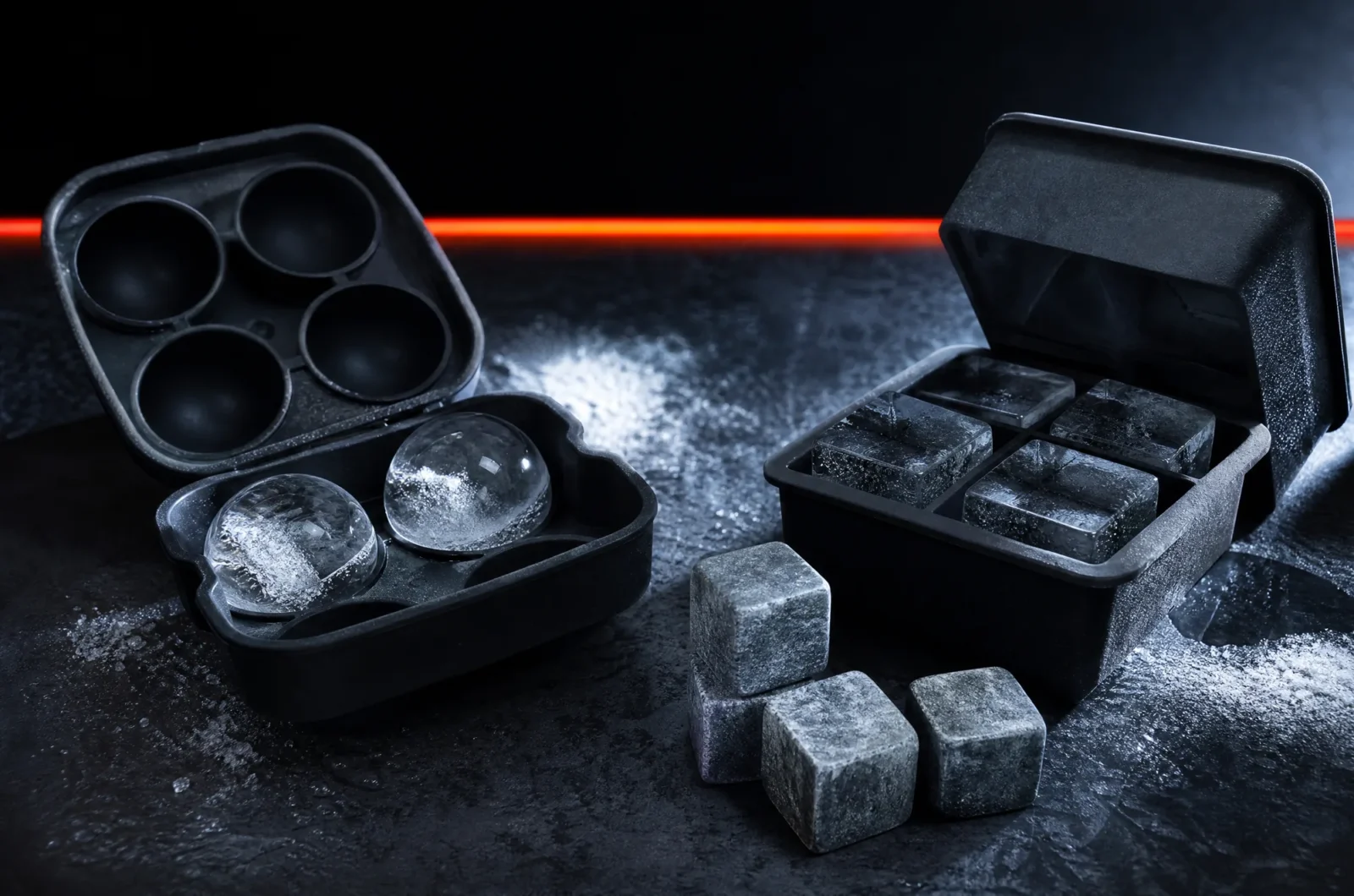 Silicone ice moulds with clear ice spheres and cubes, and soapstone chilling cubes