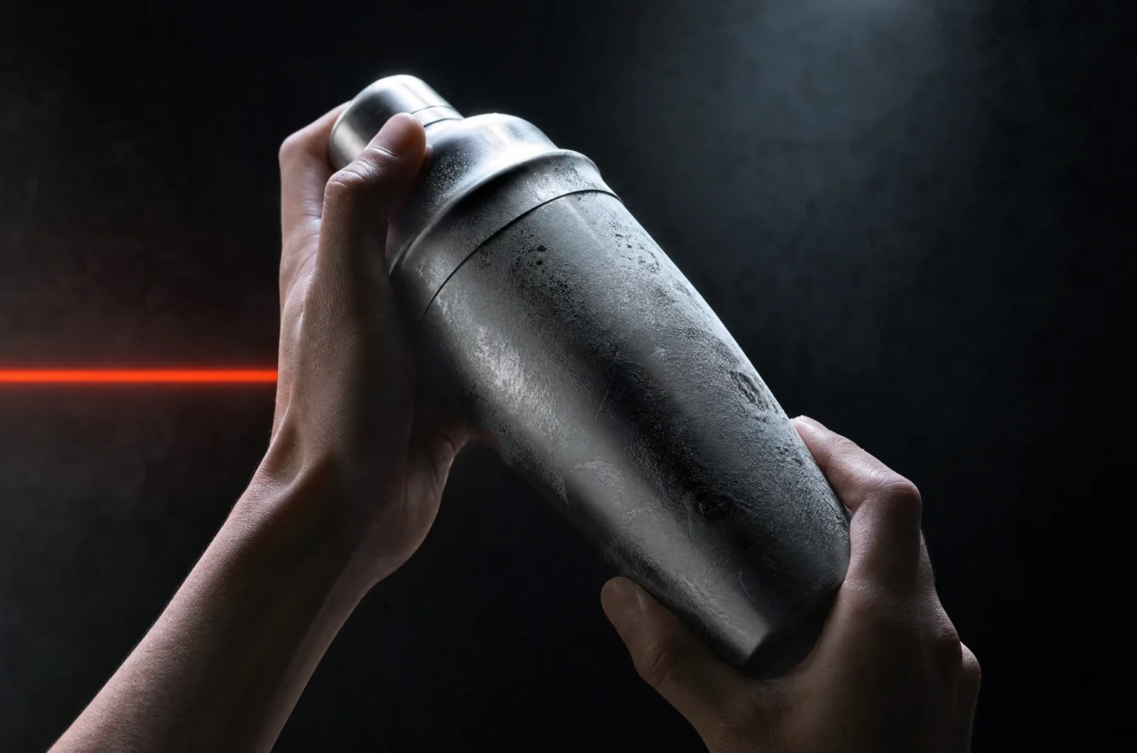 Frosted steel cobbler shaker held in two hands
